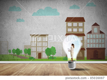 Businesswoman trapped in bulb Businesswoman trapped in bulb 85016087