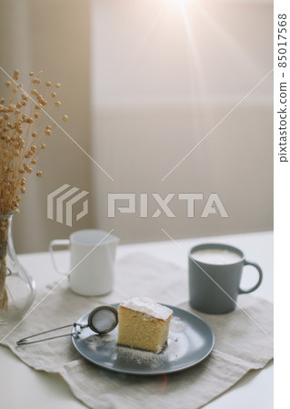 breakfast with a piece of fresh homemade cake, pitcher and cup of coffee on a table breakfast with a piece of fresh homemade cake, pitcher and cup of coffee on a table 85017568