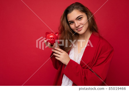 Young beautiful european stylish brunette woman wearing white blouse and red cardigan isolated over Young beautiful european stylish brunette woman wearing white blouse and red cardigan isolated over 85019466