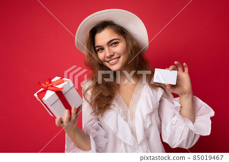 Young beautiful european stylish brunette woman wearing white blouse and fashionable hat isolated Young beautiful european stylish brunette woman wearing white blouse and fashionable hat isolated 85019467