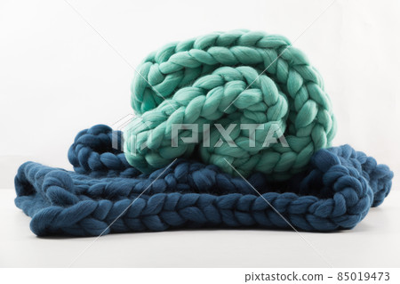 blanket for creating coziness of rough knitted handmade from natural wool on a white background blanket for creating coziness of rough knitted handmade from natural wool on a white background 85019473