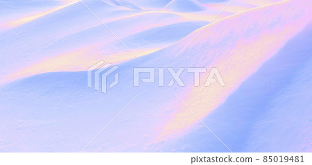 Abstract toned winter background. Surreal image in neon pink, blue and golden. Play of light and shadow on undulating slopes of white snowdrifts. Abstract toned winter background. Surreal image in neon pink, blue and golden. Play of light and shadow on undulating slopes of white snowdrifts. 85019481