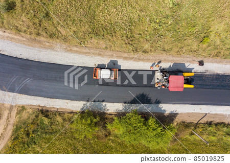 Aerial view of new road construction with asphalt laying machinery at work. 85019825