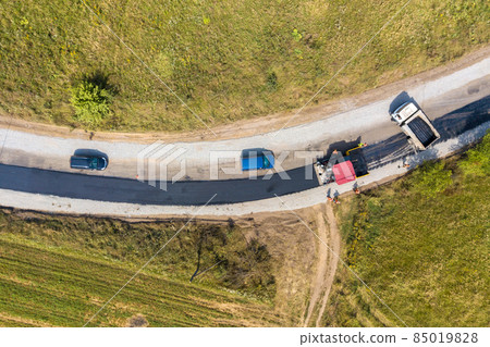 Aerial view of new road construction with asphalt laying machinery at work. 85019828