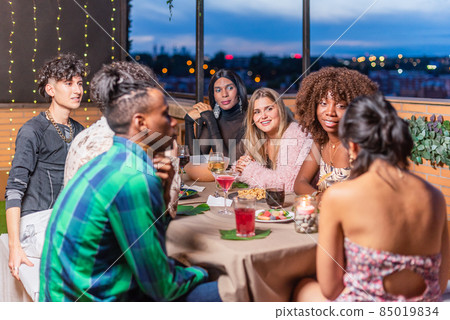 Friends celebrating New Year's Eve on balcony 85019834
