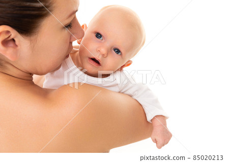 baby in the arms of a tender loving mother on a white background, baby health in the first days of 85020213