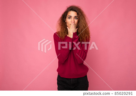 Portrait of young emotional angry beautiful brunette curly woman with sincere emotions wearing Portrait of young emotional angry beautiful brunette curly woman with sincere emotions wearing 85020291