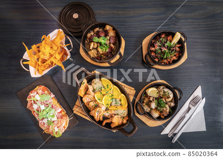 Traditional portuguese cuisine dishes of meat and fish products on a wooden table flat lay view 85020364