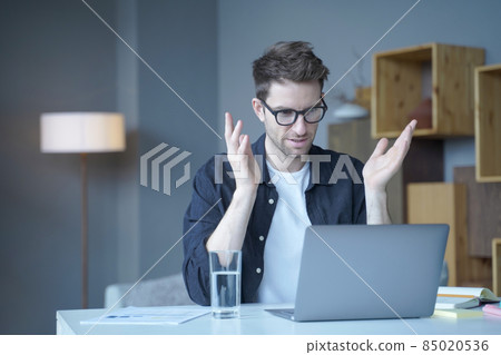 Confident European businessman team leader conducts video conference online meeting on laptop Confident European businessman team leader conducts video conference online meeting on laptop 85020536
