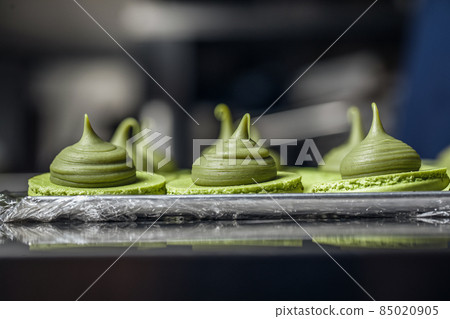 Process of making fresh handmade macaroons in restaurant kitchen. Colourful macaroons cookies on baking trays Process of making fresh handmade macaroons in restaurant kitchen. Colourful macaroons cookies on baking trays 85020905