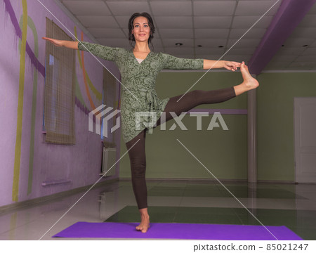 Yogi woman stretching in a studio 85021247