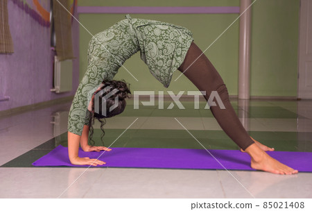 Yoga trainer showing yoga exercises Yoga trainer showing yoga exercises 85021408