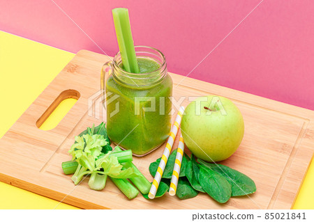 Fresh Green Smoothie of Apple, Celery, and Spinach in Glass Smoothie Jar 85021841