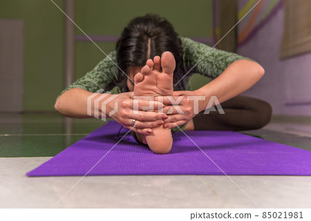 Fit girl practicing yoga exercises in the gym 85021981