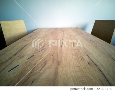 Wooden coffee table separated by line, two chairs, social distance. Concept of the new normal after covid-19. 85022720