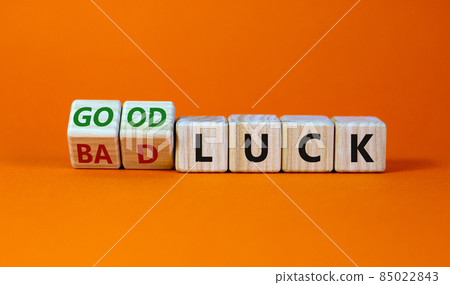 Good or bad luck symbol. Turned wooden cubes and changed words 'bad luck' to 'good luck'. Beautiful orange background, copy space. Business and good or bad luck concept. Good or bad luck symbol. Turned wooden cubes and changed words 'bad luck' to 'good luck'. Beautiful orange background, copy space. Business and good or bad luck concept. 85022843