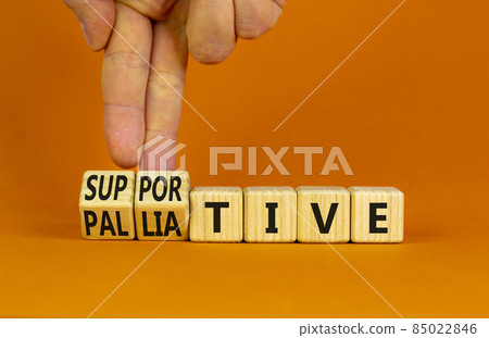 Palliative or supportive therapy symbol. Doctor turns cubes, changes words palliative to supportive. Beautiful orange background, copy space. Medical, palliative or supportive therapy concept. Palliative or supportive therapy symbol. Doctor turns cubes, changes words palliative to supportive. Beautiful orange background, copy space. Medical, palliative or supportive therapy concept. 85022846