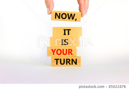 Business concept growth success process. Wood blocks stacking as step stair on white background, copy space. Businessman hand. Words 'now, it is your turn'. Conceptual image of motivation. 85022876