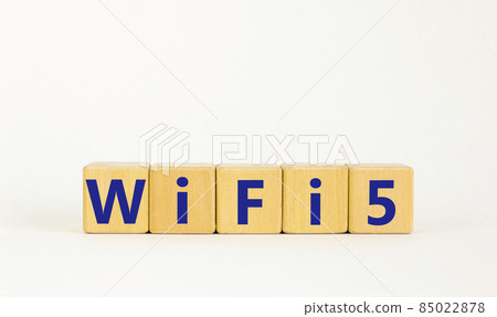 WiFi 5 symbol. The concept word WiFi 5 on wooden cubes. Beautiful white table, white background, copy space. Business, technology and WiFi 5 or WiFi5 concept. 85022878
