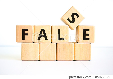 False symbol. The concept word 'false' on wooden cubes. Beautiful white table, white background, copy space. Business, true or false concept. 85022879