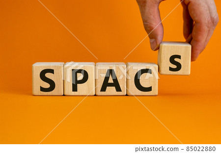 SPACs symbol. Wooden cubes with words 'SPACs, special purpose acquisition companies' on beautiful orange background, copy space. Businessman hand. Business and SPACs concept. SPACs symbol. Wooden cubes with words 'SPACs, special purpose acquisition companies' on beautiful orange background, copy space. Businessman hand. Business and SPACs concept. 85022880