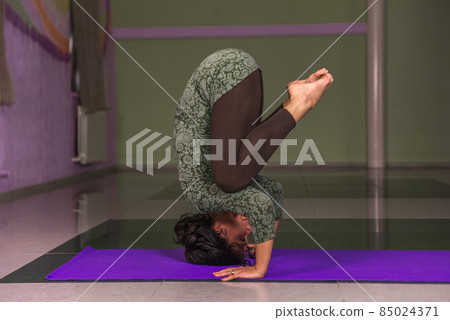 Professional yoga trainer practicing yoga lesson in a studio Professional yoga trainer practicing yoga lesson in a studio 85024371