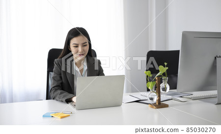 Attractive businesswoman working with modern devices in office. Attractive businesswoman working with modern devices in office. 85030270
