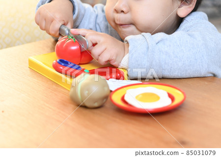 Image of a toddler boy playing house 85031079