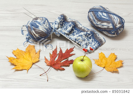 Woolen yarn for knitting. Ball of natural wool yarn and knitting needles 85031842