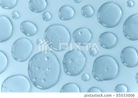 Blue doses of acid, hyaluronic moisturizing serum or gel on a monochrome background. Abstract backdrop pattern. Beauty product wallpaper. Cosmetics or healthcare protection concept.  85033006