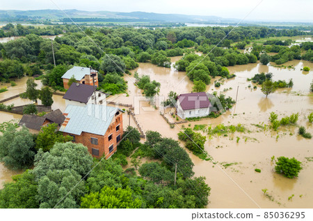 Aerial view of flooded houses with dirty water of Dnister river in Halych town, western Ukraine. Aerial view of flooded houses with dirty water of Dnister river in Halych town, western Ukraine. 85036295