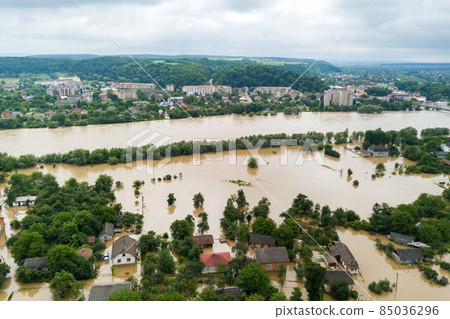 Aerial view of flooded houses with dirty water of Dnister river in Halych town, western Ukraine. Aerial view of flooded houses with dirty water of Dnister river in Halych town, western Ukraine. 85036296