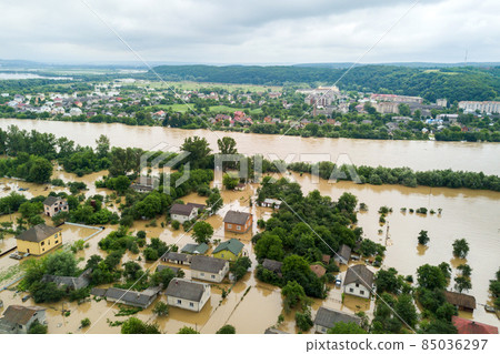 Aerial view of flooded houses with dirty water of Dnister river in Halych town, western Ukraine. Aerial view of flooded houses with dirty water of Dnister river in Halych town, western Ukraine. 85036297