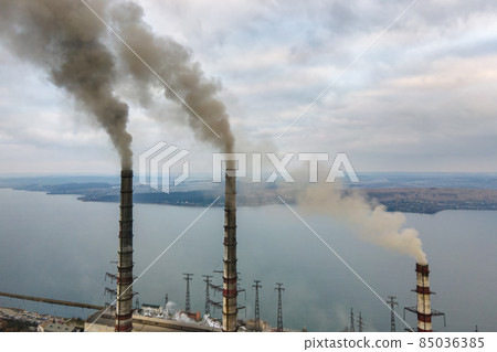 Aerial view of coal power plant high pipes with black smoke moving up polluting atmosphere. 85036385