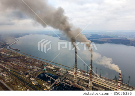 Aerial view of coal power plant high pipes with black smoke moving up polluting atmosphere. 85036386
