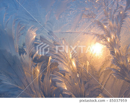 Ice pattern and sun closeup on window glass early in the morning Ice pattern and sun closeup on window glass early in the morning 85037959