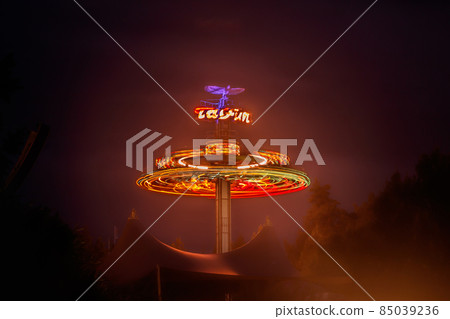 Kouvola, Finland - 28 August 2021: Rotating ride Taifun in amusement park Tykkimaki at night 85039236