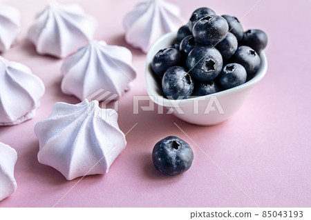 French berry meringue cookies or marshmallow and blueberries in the plate on the table close-up French berry meringue cookies or marshmallow and blueberries in the plate on the table close-up 85043193