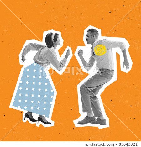 Emotional couple of dancers dressed in 70s, 80s fashion style dancing rock-and-roll on orange background with drawings. Emotional couple of dancers dressed in 70s, 80s fashion style dancing rock-and-roll on orange background with drawings. 85043321