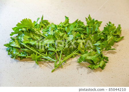 Fresh harvest of bright green parsley on the stone table 85044210