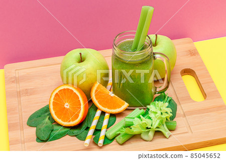 Fresh Green Smoothie of Apple, Celery, Spinach and Orange in Glass Smoothie Jar 85045652