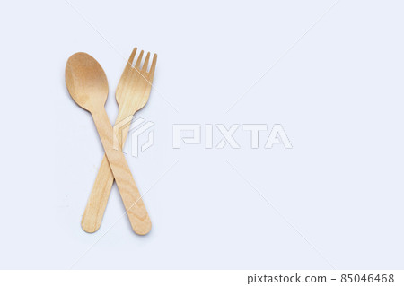 Wooden spoon and fork on white background. Wooden spoon and fork on white background. 85046468