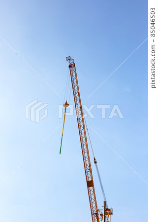 Yellow cranes on sky background. Yellow cranes on sky background. 85046503