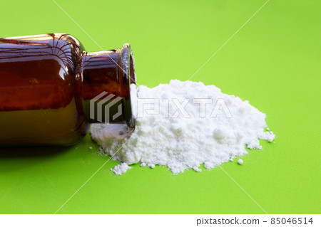 Baking soda on green background. Baking soda on green background. 85046514