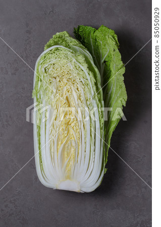 Half of a Peking cabbage in close-up on a gray background. 85050929