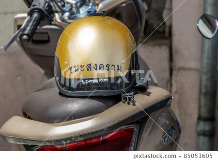 A Thailand police helmet on the saddle of a police motorcycle at Chana Songkhram Metropolitan Police Station. 85051605