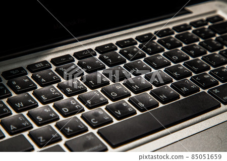 Close-up detail view of a laptop keyboard on the keys with high contrast and shallow depth of field. 85051659