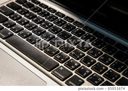 Close-up detail view of a laptop keyboard on the keys with high contrast and shallow depth of field. 85051674