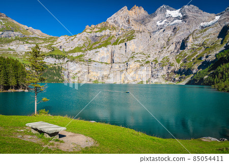 Resting place on the lake shore, Oeschinensee lake, Switzerland 85054411