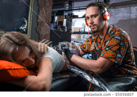 Professional tattooist working on professional tattoo machine device in the salon 85056807